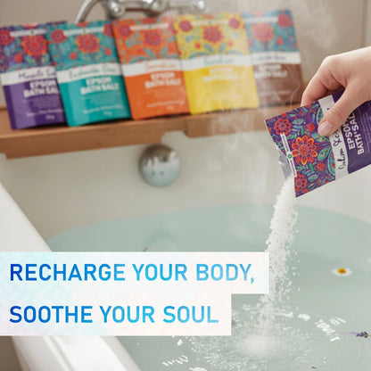 Person pouring bath salts into a bathtub with colorful packaging in the background.