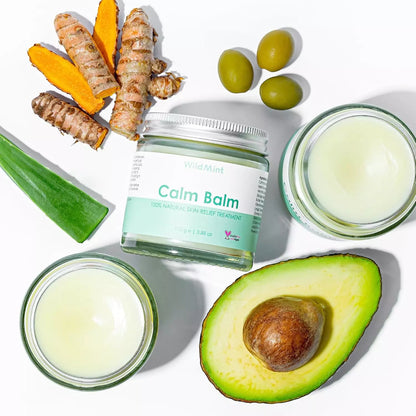Calm Balm jar with natural ingredients like avocado, turmeric, and olives on a white background